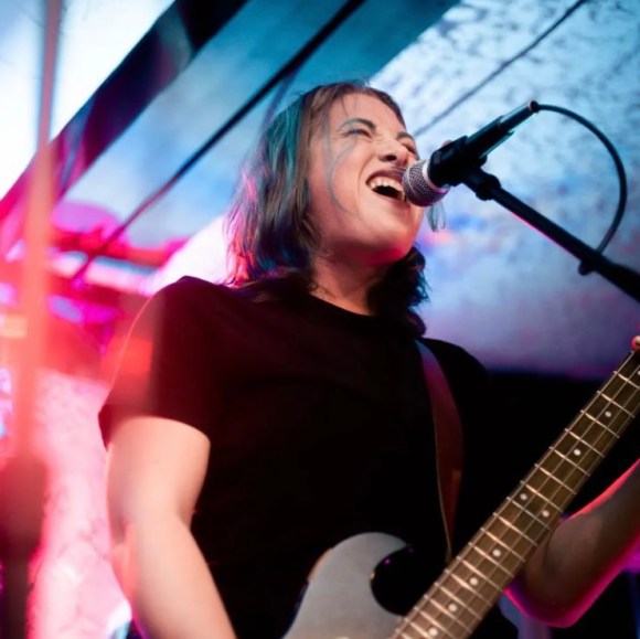 Edith playing bass and singing