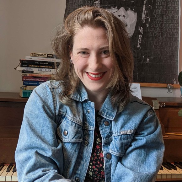 Edith sitting down and smiling into camera